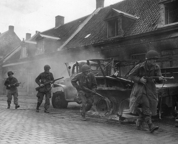 MG Day 7 - 101st Airborne paratroopers move past a burning truck in the town of Veghel on September 23..jpg